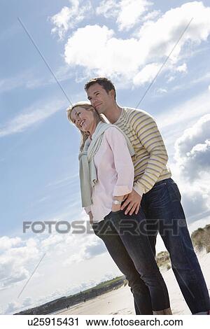 Couple embracing on beach View Large Photo Image Stock Image - Couple embracing on beach. Fotosearch