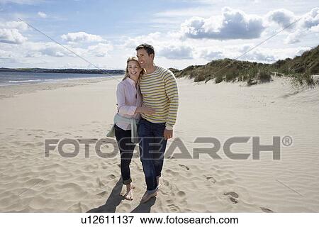 Stock Photo - Couple embracing on beach. Fotosearch