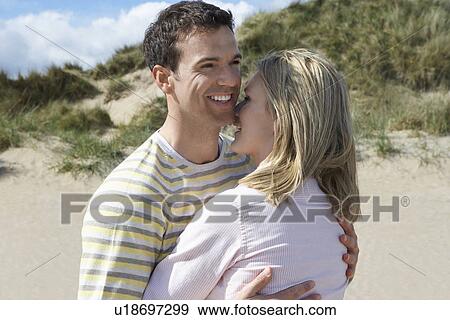 Stock Photo - Couple embracing on beach. Fotosearch
