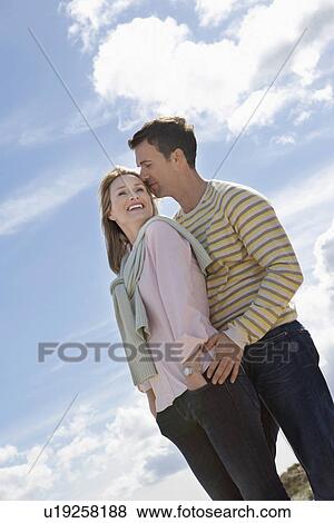 Stock Photo - Couple embracing on beach. Fotosearch