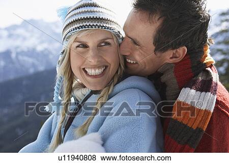 Stock Photo - Couple embracing on mountain peak side view portrait. Fotosearch