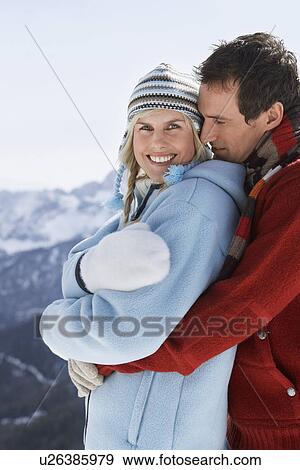Couple embracing on mountain peak side view portrait View Large Photo Image Stock Photo - Couple embracing on mountain peak side view portrait. Fotosearch