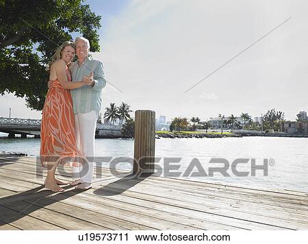 Couple embracing standing on pier portrait View Large Photo Image Stock Image - Couple embracing standing on pier portrait. Fotosearch