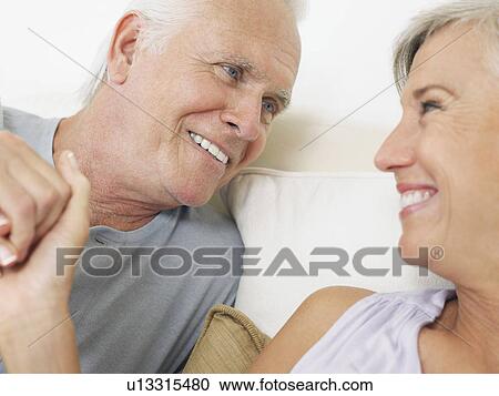 Couple holding hands and looking in eyes close-up View Large Photo Image Stock Image - Couple holding hands and looking in eyes close-up. Fotosearch