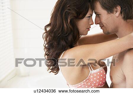Stock Photograph - Couple in underwear embracing side view. Fotosearch