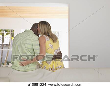 Couple leaning on sofa back view View Large Photo Image Picture - Couple leaning on sofa back view. Fotosearch