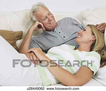 Couple lying on bed View Large Photo Image Stock Image - Couple lying on bed. Fotosearch