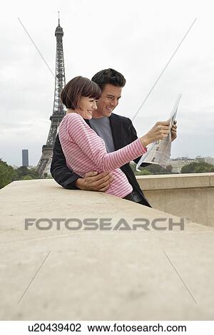 Stock Image - Couple Reading City Map. Fotosearch
