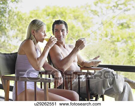 Couple sitting on terrace drinking man looking at woman View Large Photo Image Stock Image - Couple sitting on terrace drinking man looking at woman. Fotosearch
