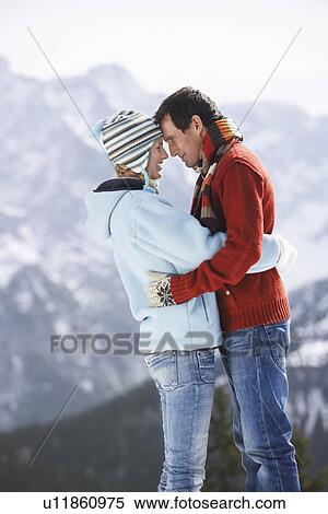 Couple standing face to face in mountains side view View Large Photo Image Stock Photography - Couple standing face to face in mountains side view. Fotosearch