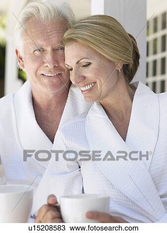 Stock Image - Couple standing on verandah portrait. Fotosearch