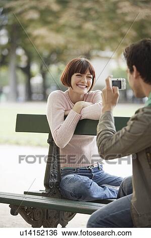 Stock Photograph - Couple Using Digital Camera in Park. Fotosearch