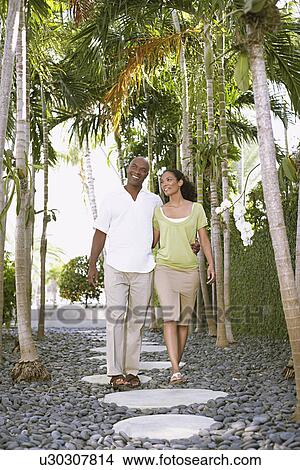 Picture - Couple walking on path. Fotosearch