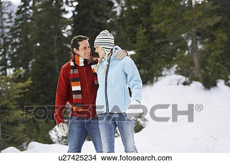Picture - Couple walking on snow-covered path. Fotosearch