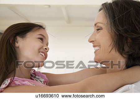 Daughter hugging mother head and shoulders side view View Large Photo Image Stock Image - Daughter hugging mother head and shoulders side view. Fotosearch