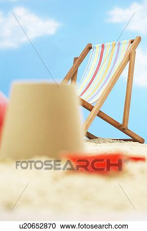 Deck chair behind and castle on beach View Large Photo Image Stock Image - Deck chair behind and castle on beach. Fotosearch