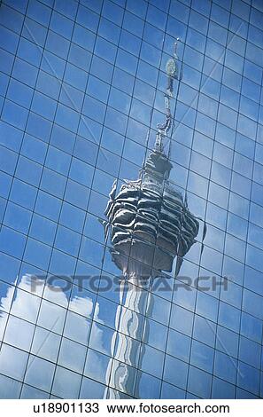 Stock Image - Distorted reflection of Kuala Lumpur Tower in building wall full frame. Fotosearch