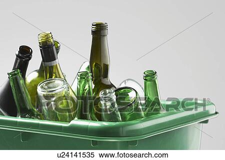 Stock Photography - Empty bottles in green container close-up. Fotosearch