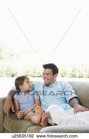 Father and daughter (5-6) relaxing on sofa View Large Photo Image Stock Image - Father and daughter (5-6) relaxing on sofa. Fotosearch