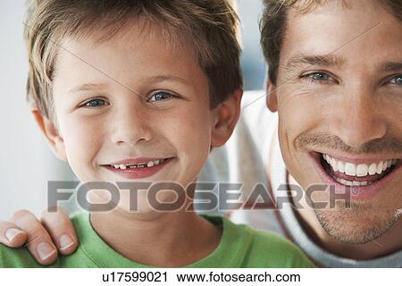 Stock Image - Father and Son smiling head and shoulders portrait. Fotosearch