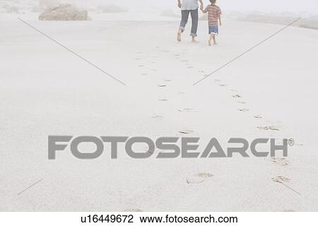 Father and Son Strolling on Beach View Large Photo Image Stock Image - Father and Son Strolling on Beach. Fotosearch