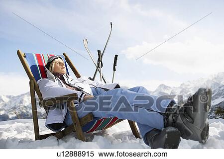Female skier resting on deckchair in mountains View Large Photo Image Stock Photography - Female skier resting on deckchair in mountains. Fotosearch