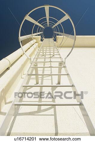 Stock Image - Fire escape leading to roof view from below. Fotosearch
