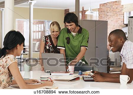 Four office workers having meeting. View Large Photo Image Picture - Four office workers having meeting.. Fotosearch
