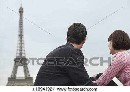 France Paris Couple looking at Eiffel Tower back view View Large Photo Image Stock Photo - France Paris Couple looking at Eiffel Tower back view. Fotosearch