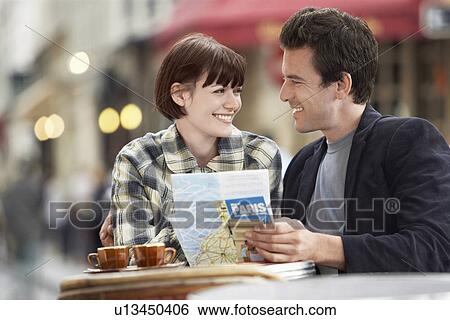 France Paris Couple reading map sitting outside cafe View Large Photo Image Stock Photograph - France Paris Couple reading map sitting outside cafe. Fotosearch