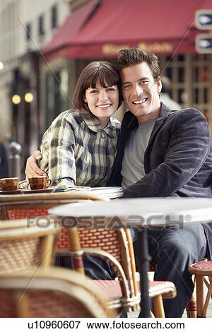 France Paris Couple sitting outside cafe View Large Photo Image Stock Photo - France Paris Couple sitting outside cafe. Fotosearch