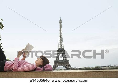 France Paris Young woman reading book on balcony in front of Eiffel Tower View Large Photo Image Stock Image - France Paris Young woman reading book on balcony in front of Eiffel Tower. Fotosearch