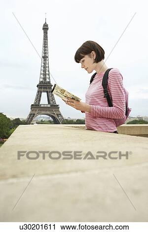 France Paris Young woman reading book on balcony in front of Eiffel Tower View Large Photo Image Stock Image - France Paris Young woman reading book on balcony in front of Eiffel Tower. Fotosearch