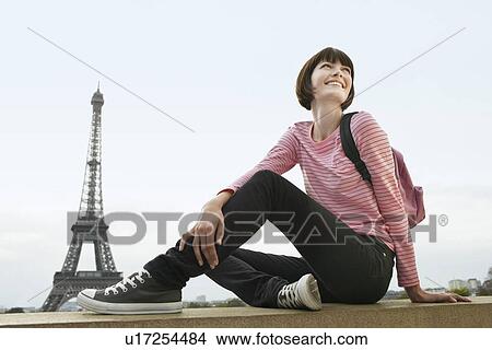 France Paris Young woman sitting on balcony in front of Eiffel Tower View Large Photo Image Picture - France Paris Young woman sitting on balcony in front of Eiffel Tower. Fotosearch