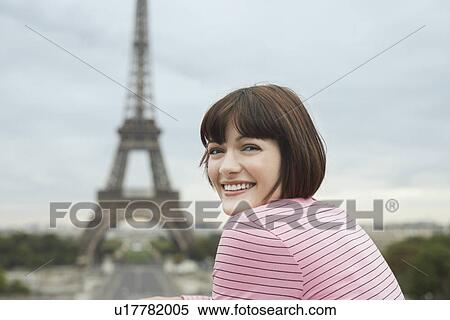 France Paris Young woman smiling with Eiffel Tower in distance View Large Photo Image Stock Photography - France Paris Young woman smiling with Eiffel Tower in distance. Fotosearch