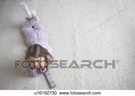 Girl (5-6) lying on rug view from above View Large Photo Image Stock Image - Girl (5-6) lying on rug view from above. Fotosearch