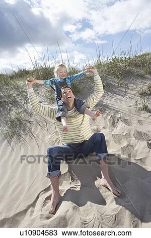 Girl (5-6) on fathers shoulders at beach View Large Photo Image Stock Image - Girl (5-6) on fathers shoulders at beach. Fotosearch