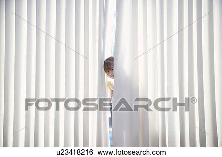 Girl (5-6) peeking from behind blinds View Large Photo Image Stock Photograph - Girl (5-6) peeking from behind blinds. Fotosearch