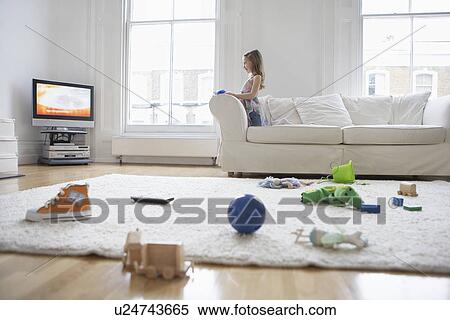 Girl (5-6) watching television toys on floor in foreground View Large Photo Image Stock Photography - Girl (5-6) watching television toys on floor in foreground. Fotosearch