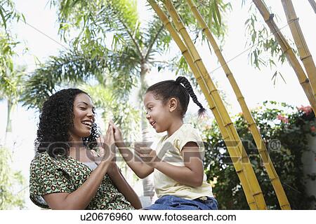 Girl (5-6 years) clapping hands with mother in forest low angle view View Large Photo Image Stock Image - Girl (5-6 years) clapping hands with mother in forest low angle view. Fotosearch