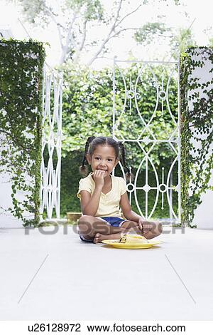 Girl (5-6 years) sitting on verandah floor eating View Large Photo Image Stock Image - Girl (5-6 years) sitting on verandah floor eating. Fotosearch