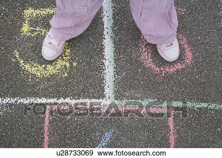 Girl (7-9) playing hop-scotch in school playground low section View Large Photo Image Stock Photo - Girl (7-9) playing hop-scotch in school playground low section. Fotosearch