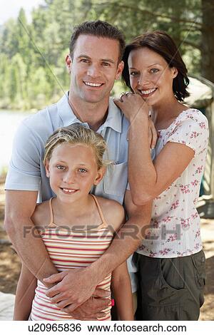Girl (7-9) standing outdoors with mother and father. View Large Photo Image Stock Photograph - Girl (7-9) standing outdoors with mother and father.. Fotosearch