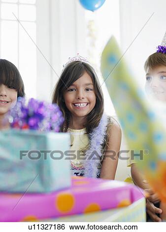 Girl and birthday guests (7-9) presents in foreground View Large Photo Image Stock Photograph - Girl and birthday guests (7-9) presents in foreground. Fotosearch