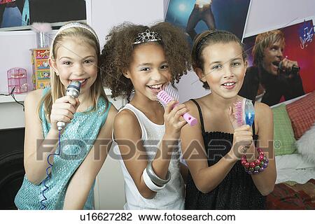 Girls using brushes microphones to sing at a Slumber Party View Large Photo Image Stock Image - Girls using brushes microphones to sing at a Slumber Party. Fotosearch