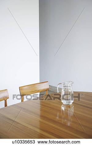 Stock Image - Glass jar on wooden table. Fotosearch