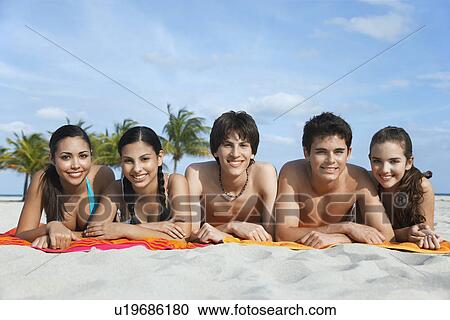 Group of teenagers (16-17) lying in row on beach towels portrait View Large Photo Image Stock Image - Group of teenagers (16-17) lying in row on beach towels portrait. Fotosearch