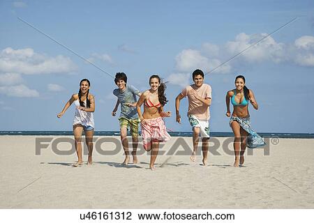 Group of teenagers (16-17) running on beach View Large Photo Image Stock Image - Group of teenagers (16-17) running on beach. Fotosearch