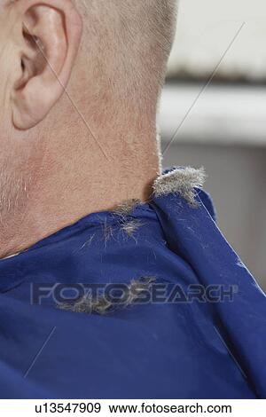Stock Photo - Hair on mans shoulders after haircut at barbers close-up. Fotosearch