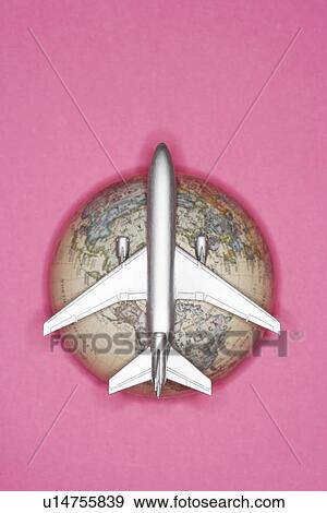 Imitation plane over globe studio shot view from above View Large Photo Image Stock Photo - Imitation plane over globe studio shot view from above. Fotosearch